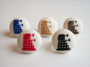 Daleks from the BBC show Dr. Who in cross-stitched ring form. Source.